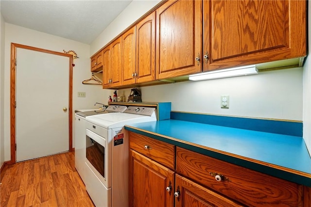 79 Mariacher Rd, Findley Twp, PA 16137 - kitchen with washer and dryer, brown cabinets, light wood-style floors, and light countertops