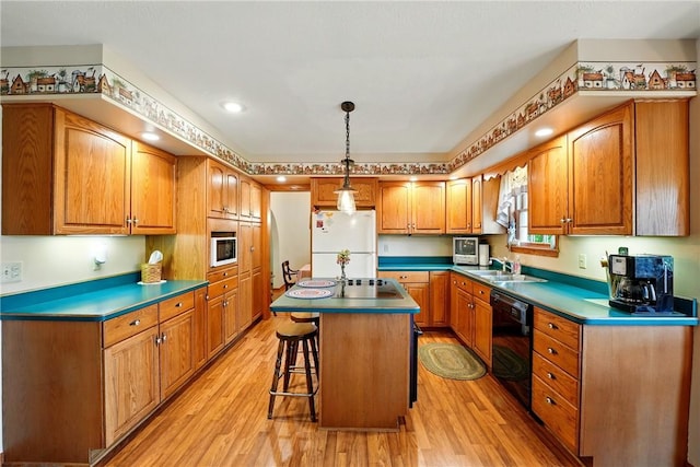 79 Mariacher Rd, Findley Twp, PA 16137 - kitchen with freestanding refrigerator, dishwasher, light wood-type flooring, a center island, and brown cabinetry