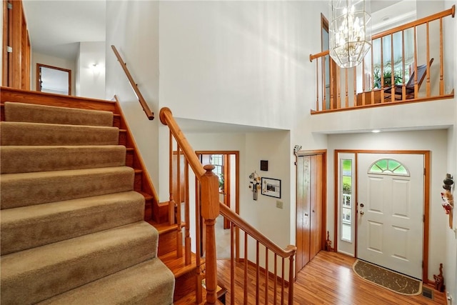 79 Mariacher Rd, Findley Twp, PA 16137 - foyer entrance featuring wood finished floors, stairway, a chandelier, a high ceiling, and baseboards