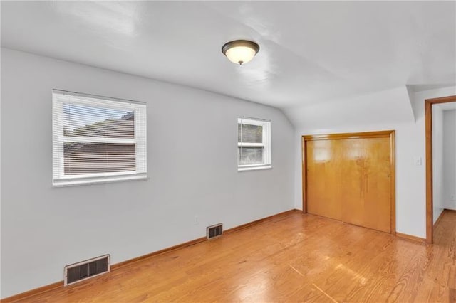 427 Cedar St, Jeannette, PA 15644 - unfurnished bedroom featuring light wood-style floors, a closet, baseboards, and vaulted ceiling