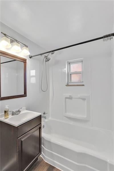 427 Cedar St, Jeannette, PA 15644 - bathroom featuring vanity, shower / bathtub combination, and wood finished floors