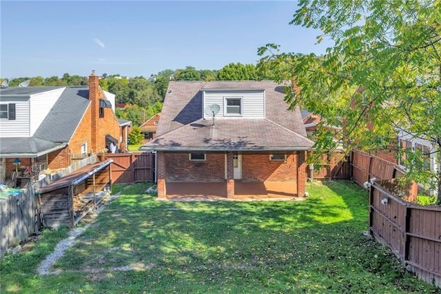 427 Cedar St, Jeannette, PA 15644 - rear view of house featuring brick siding and a patio area