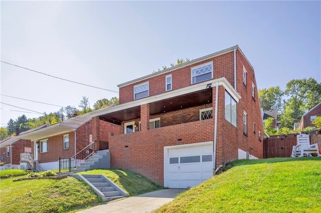 427 Cedar St, Jeannette, PA 15644 - view of front of property with an attached garage, brick siding, a front yard, and driveway