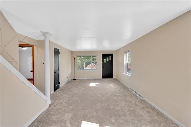 427 Cedar St, Jeannette, PA 15644 - foyer with light colored carpet, baseboards, and decorative columns