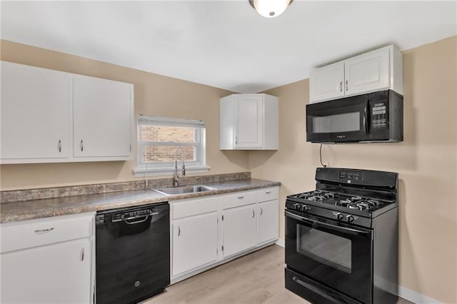 427 Cedar St, Jeannette, PA 15644 - kitchen with black appliances, a sink, white cabinetry, and light wood-style flooring