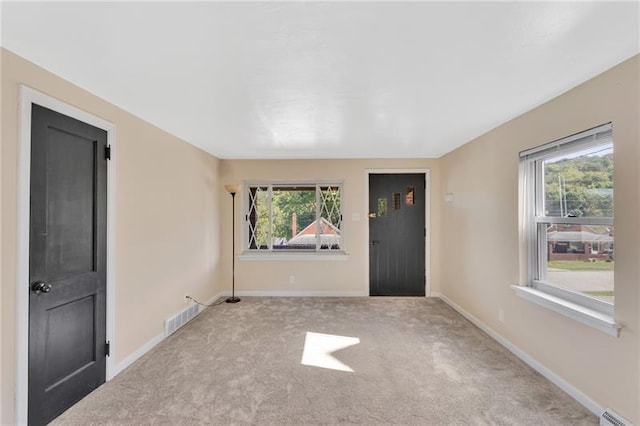 427 Cedar St, Jeannette, PA 15644 - carpeted empty room with plenty of natural light and baseboards
