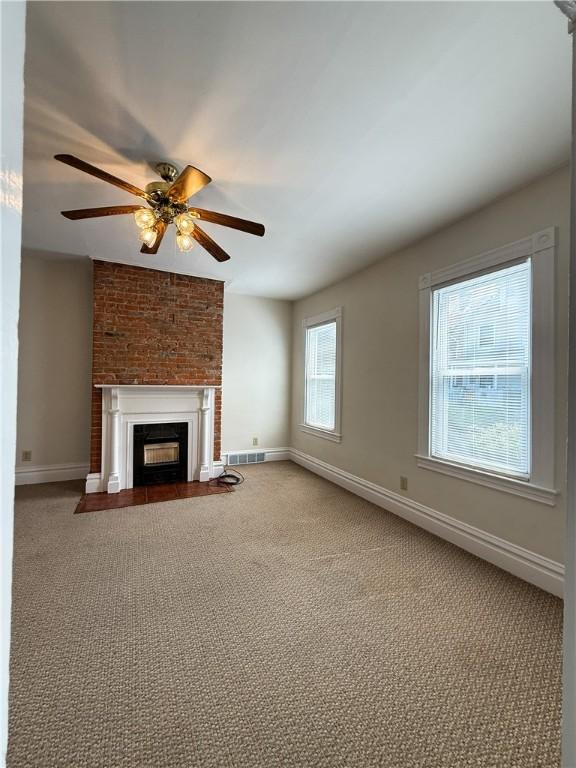 610 Southern Ave, Mt Washington, PA 15211 - unfurnished living room with carpet flooring, a ceiling fan, a fireplace with flush hearth, and baseboards