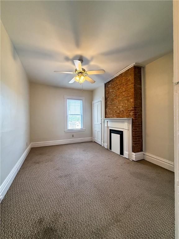 610 Southern Ave, Mt Washington, PA 15211 - unfurnished living room with carpet floors, a fireplace, ceiling fan, and baseboards