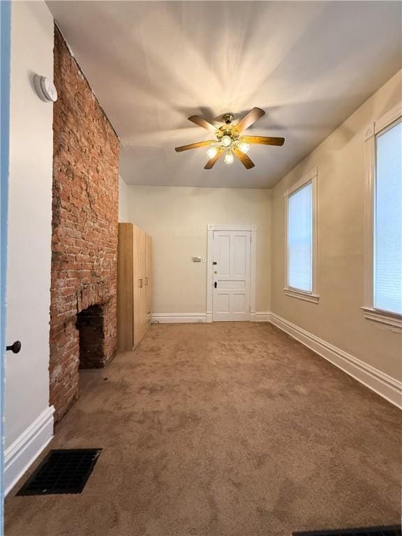 610 Southern Ave, Mt Washington, PA 15211 - unfurnished living room featuring ceiling fan, carpet, a stone fireplace, and baseboards