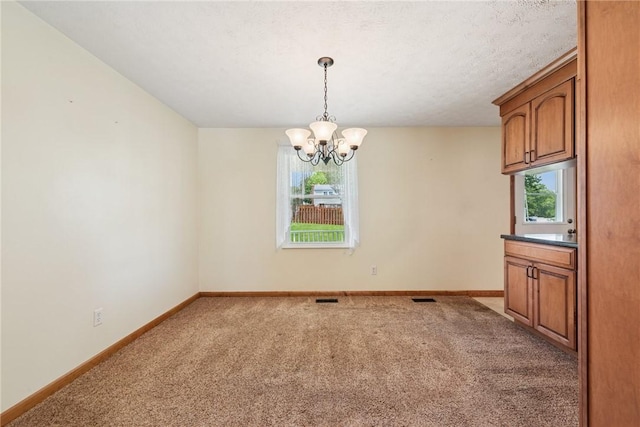 211 Old Meadow Dr, Hempfield Twp Wml, PA 15601 - unfurnished dining area with light colored carpet, a chandelier, baseboards, and plenty of natural light