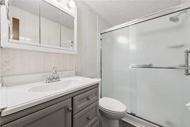 211 Old Meadow Dr, Hempfield Twp Wml, PA 15601 - bathroom featuring a shower stall, vanity, toilet, backsplash, and tile walls