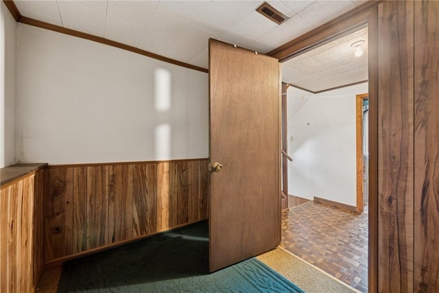 211 Old Meadow Dr, Hempfield Twp Wml, PA 15601 - spare room with wood walls, ornamental molding, and a wainscoted wall