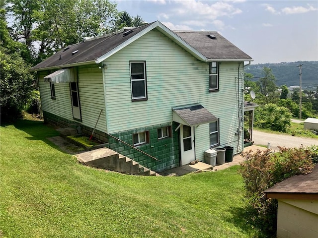 76 Laurel Rd, Fallowfield, PA 15022 - rear view of property featuring a lawn and roof with shingles