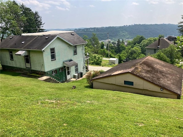 76 Laurel Rd, Fallowfield, PA 15022 - rear view of house featuring a lawn, a shingled roof, and central air condition unit