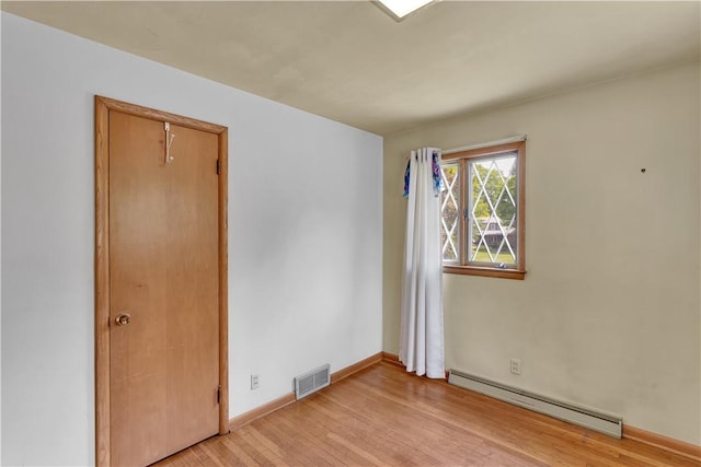 17 Lakeview Dr, Lackawannock Twp, PA 16159 - empty room with a baseboard heating unit, light wood-style floors, and baseboards