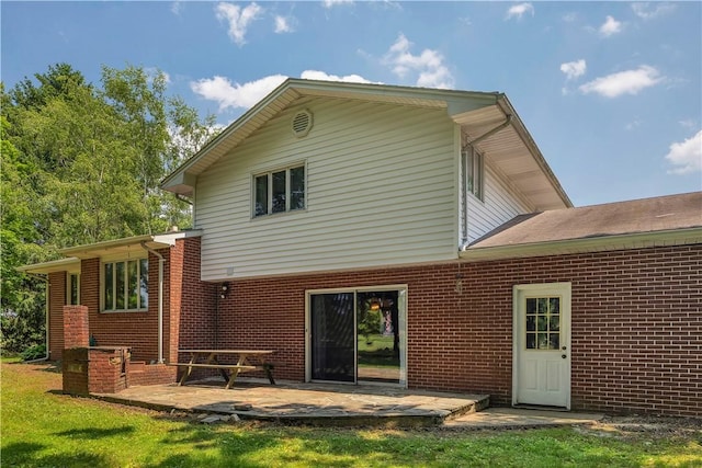 17 Lakeview Dr, Lackawannock Twp, PA 16159 - rear view of house with brick siding, a patio area, and a lawn