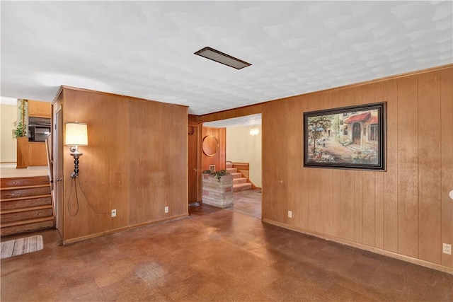 17 Lakeview Dr, Lackawannock Twp, PA 16159 - spare room featuring stairs, wood walls, and baseboards