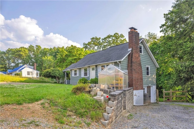 341 State Route 356, Washington Twp Wml, PA 15613 - view of front of property featuring a greenhouse, a chimney, and an outbuilding