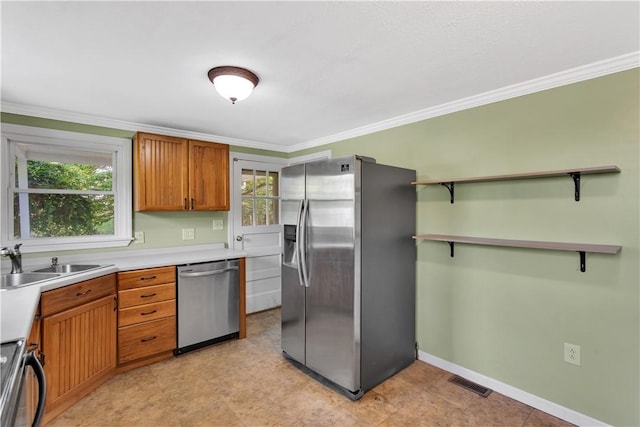 341 State Route 356, Washington Twp Wml, PA 15613 - kitchen with appliances with stainless steel finishes, a sink, light countertops, crown molding, and brown cabinetry