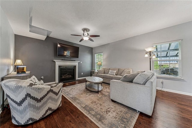 4054 Bentwood Dr, North Strabane, PA 15317 - living room with ceiling fan, wood finished floors, baseboards, a glass covered fireplace, and a textured ceiling