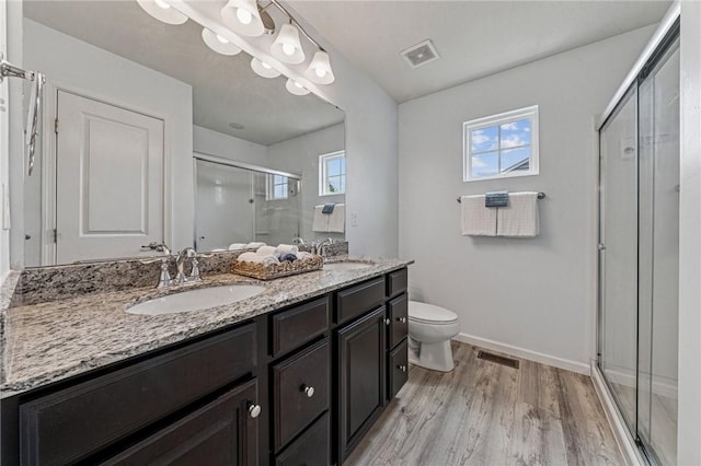 4054 Bentwood Dr, North Strabane, PA 15317 - bathroom featuring double vanity, a shower stall, toilet, wood finished floors, and healthy amount of natural light