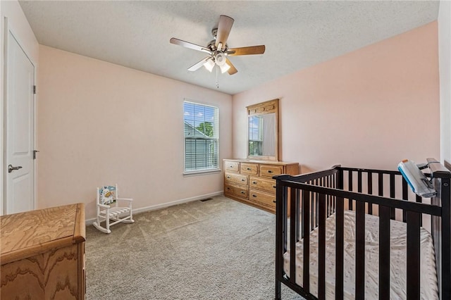 4054 Bentwood Dr, North Strabane, PA 15317 - carpeted bedroom with baseboards, ceiling fan, a nursery area, and a textured ceiling