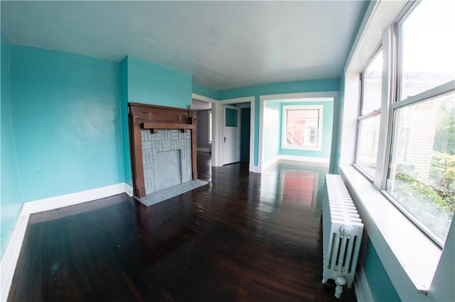 222-224 Alice St, Mount Oliver, PA 15210 - unfurnished living room with radiator heating unit, baseboards, dark wood-style floors, and a stone fireplace