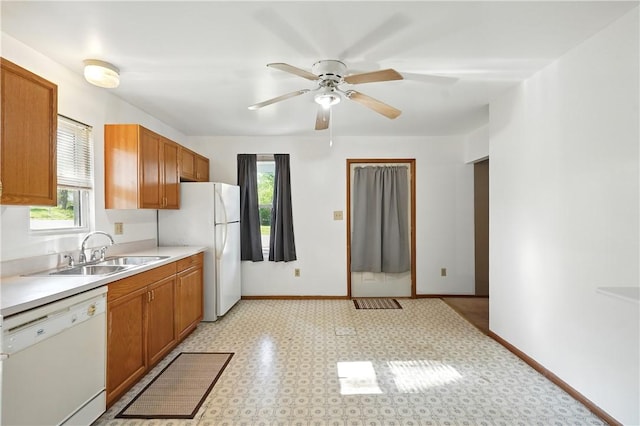 3009 33rd St, Pulaski Twp Bea, PA 15066 - kitchen with white appliances, a sink, healthy amount of natural light, and brown cabinets