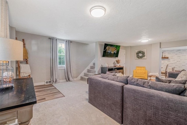 126 Scholl Ln, Rostraver, PA 15012 - carpeted living room with stairway, a textured ceiling, and baseboards