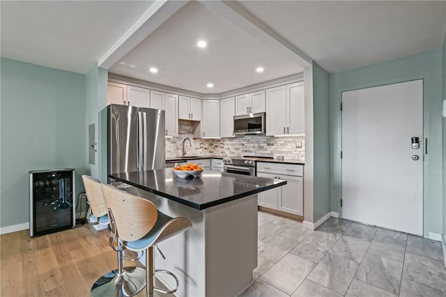 611 N Calais Dr Unit 4212, Mccandless, PA 15237 - kitchen featuring stainless steel appliances, beverage cooler, decorative backsplash, a kitchen bar, and dark countertops