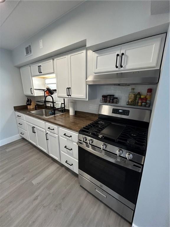 1326 6th Ave Unit 401, Beaver Falls, PA 15010 - kitchen with stainless steel range with gas cooktop, light wood finished floors, white cabinets, baseboards, and a sink