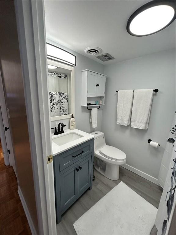 1326 6th Ave Unit 401, Beaver Falls, PA 15010 - full bath featuring vanity, toilet, wood finished floors, baseboards, and a shower with curtain