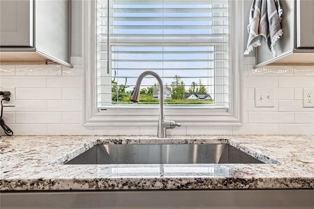 137 Summer Ln, Mount Pleasant Twp Was, PA 15057 - kitchen view of a sink, light stone countertops, and backsplash