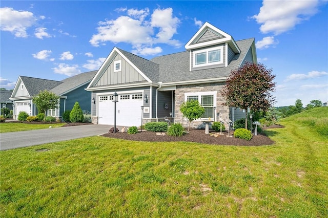 137 Summer Ln, Mount Pleasant Twp Was, PA 15057 - view of front facade featuring board and batten siding, stone siding, driveway, an attached garage, and a front yard