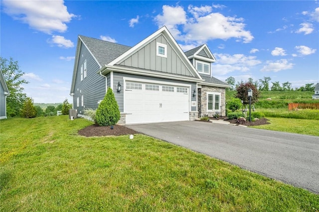 137 Summer Ln, Mount Pleasant Twp Was, PA 15057 - view of front of house with board and batten siding, driveway, stone siding, a front yard, and central air condition unit