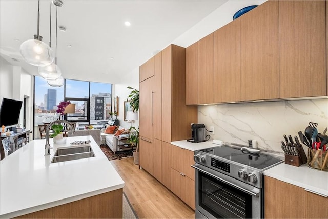 2554 Smallman St Unit 406, Downtown Pgh, PA 15222 - kitchen with electric stove, a sink, open floor plan, modern cabinets, and light countertops
