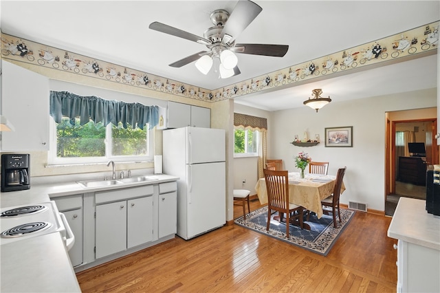 131 Howley Ave, Chippewa Twp, PA 15010 - kitchen with white appliances, a sink, light countertops, and light wood-style floors