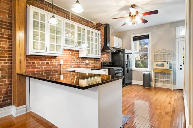 1812 Carey Way S, Side, PA 15203 - kitchen with wall chimney exhaust hood, white microwave, a peninsula, light wood-style floors, and baseboards