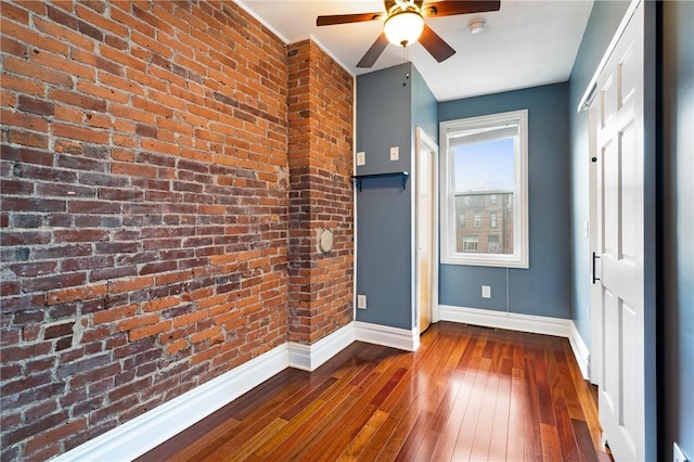 1812 Carey Way S, Side, PA 15203 - unfurnished bedroom with baseboards, dark wood-style floors, brick wall, and a ceiling fan