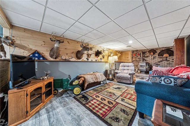 922 Old Ridge Rd, Cross Creek Twp, PA 15340 - living room featuring a wood stove, a paneled ceiling, wood finished floors, and wooden walls