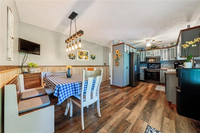 922 Old Ridge Rd, Cross Creek Twp, PA 15340 - dining space with a wainscoted wall, a ceiling fan, dark wood finished floors, and wooden walls