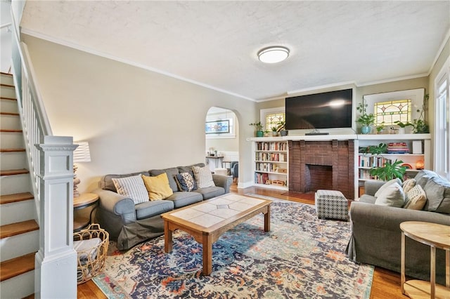 1403 Creedmoor Ave, Brookline, PA 15226 - living area with light wood-style flooring, arched walkways, crown molding, stairs, and a brick fireplace