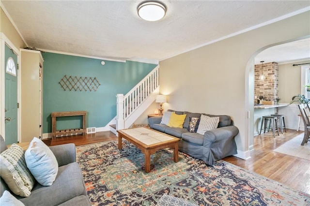 1403 Creedmoor Ave, Brookline, PA 15226 - living room with arched walkways, wood finished floors, stairs, ornamental molding, and baseboards