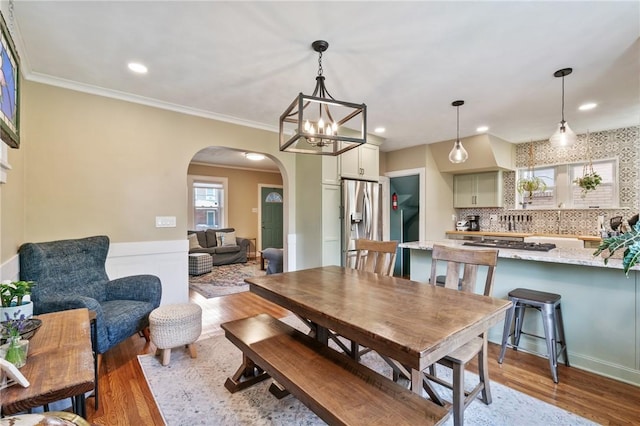1403 Creedmoor Ave, Brookline, PA 15226 - dining space featuring arched walkways, wood finished floors, recessed lighting, ornamental molding, and wainscoting