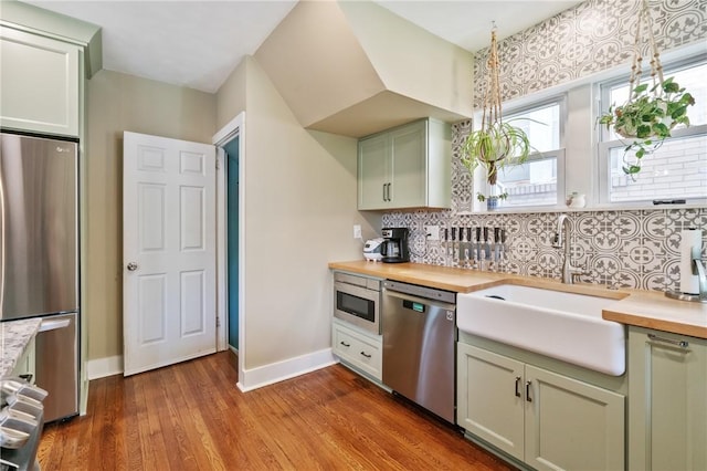 1403 Creedmoor Ave, Brookline, PA 15226 - kitchen with stainless steel appliances, butcher block counters, a sink, baseboards, and backsplash