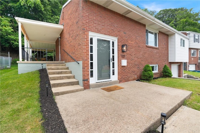 127 Greenview Dr, Penn Hills, PA 15147 - doorway to property with brick siding, a yard, and a patio area