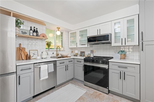 127 Greenview Dr, Penn Hills, PA 15147 - kitchen with stainless steel appliances, gray cabinets, decorative backsplash, and a sink