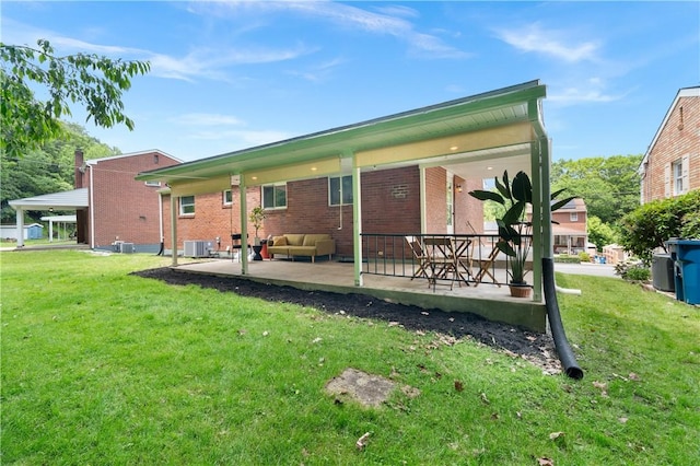 127 Greenview Dr, Penn Hills, PA 15147 - back of house featuring a lawn, a patio, brick siding, and central air condition unit