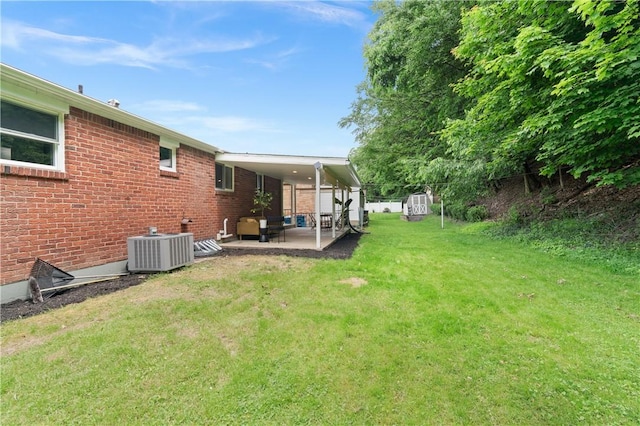 127 Greenview Dr, Penn Hills, PA 15147 - view of green lawn featuring central air condition unit and a patio