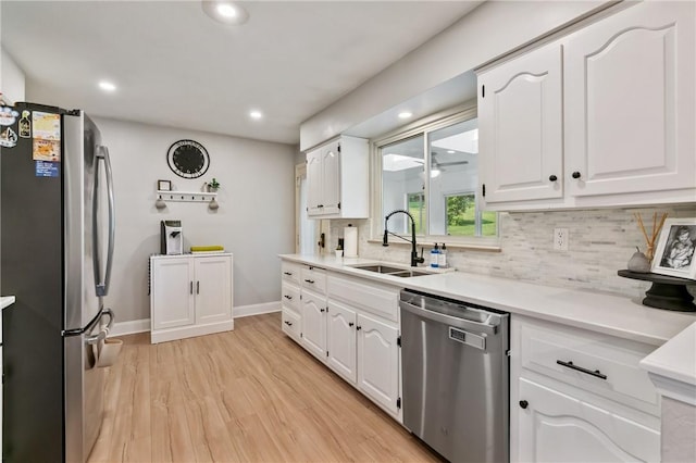 208 Chan Mowr Dr, Middlesex Twp, PA 16059 - kitchen with appliances with stainless steel finishes, a sink, tasteful backsplash, white cabinets, and baseboards